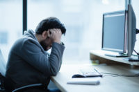 Depressed upset office worker having a headache problem